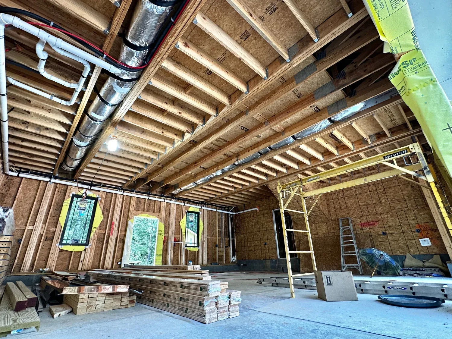 Open-span interior framing with mechanical rough-in on a Hale Development build in progress